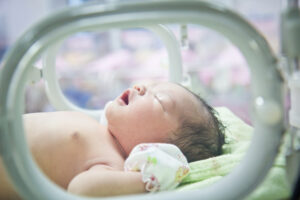A baby is in an incubator. 