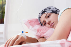 A girl lying in a hospital bed after a delayed diagnosis means that she requires invasive treatments