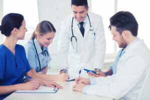 Medical practitioners gather round a table to discuss whether a claimant suffered due a doctor failing to provide the appropriate standard of care