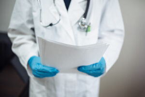 Doctor holding papers.