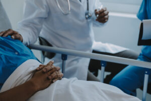 An injured patient lays in a hospital bed 