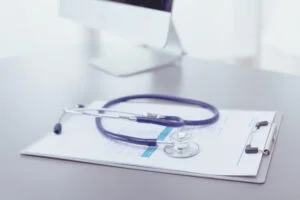Image of stethoscope folded on a desk.