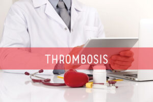 A doctor holding a tablet with the word 'thrombosis' emblazoned on the image.